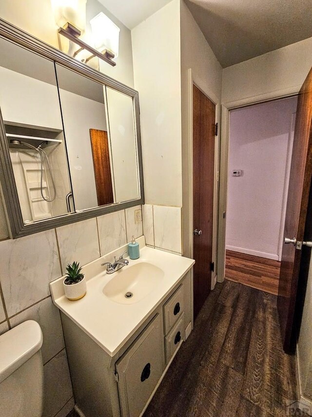 3112 Withers Ave, Pueblo, CO 81008 - bathroom featuring wood finished floors, vanity, and toilet