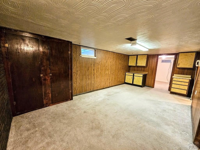 3112 Withers Ave, Pueblo, CO 81008 - basement featuring wood walls and light colored carpet