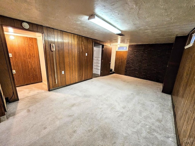 3112 Withers Ave, Pueblo, CO 81008 - finished basement featuring wood walls, carpet flooring, and a textured ceiling
