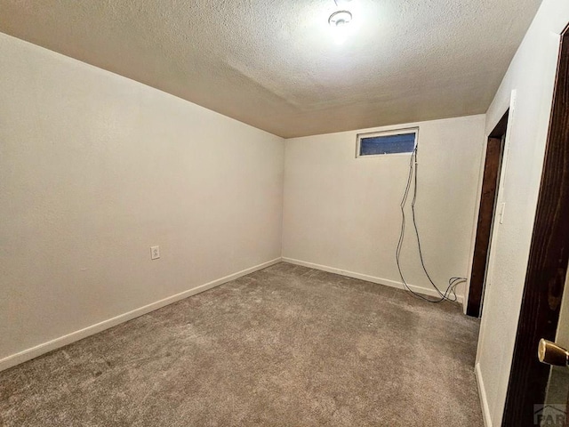 3112 Withers Ave, Pueblo, CO 81008 - spare room featuring a textured ceiling, carpet flooring, and baseboards