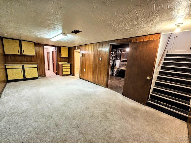 3112 Withers Ave, Pueblo, CO 81008 - unfurnished bedroom featuring wooden walls, carpet flooring, and a walk in closet