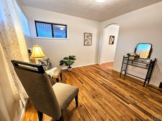 3112 Withers Ave, Pueblo, CO 81008 - living area with arched walkways, wood finished floors, and baseboards