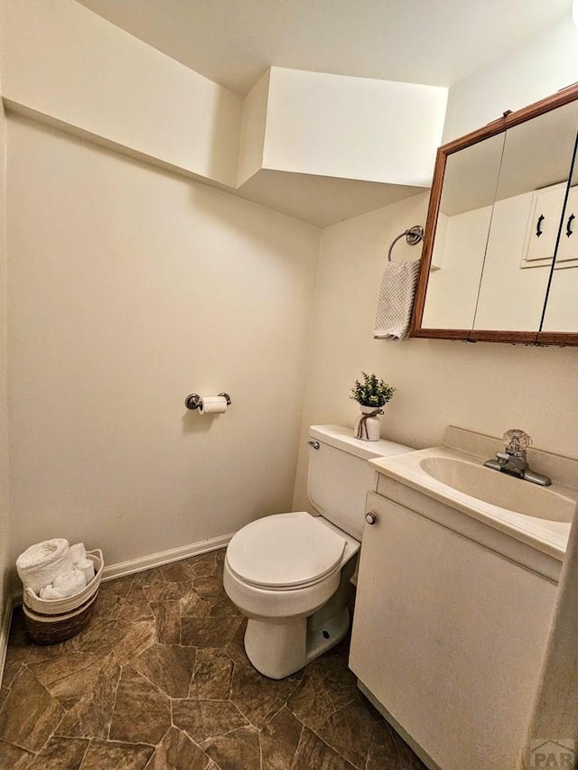 3112 Withers Ave, Pueblo, CO 81008 - half bathroom with toilet, vanity, and baseboards
