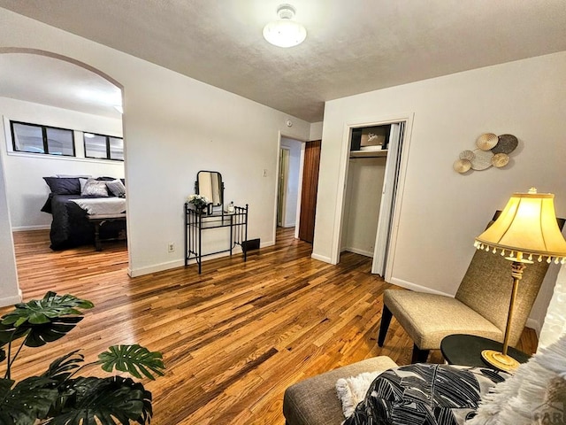 3112 Withers Ave, Pueblo, CO 81008 - living area with wood finished floors, arched walkways, and baseboards