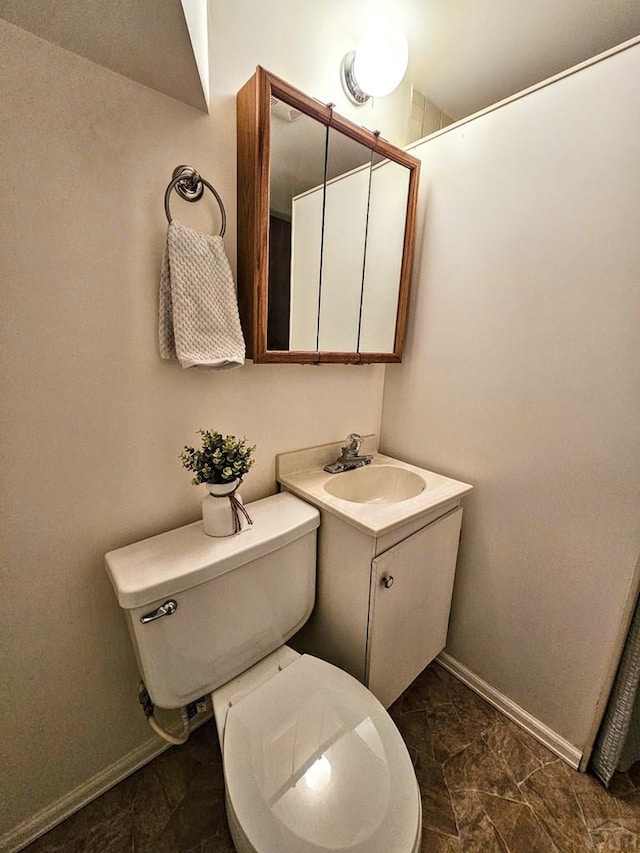 3112 Withers Ave, Pueblo, CO 81008 - bathroom with toilet, baseboards, and vanity
