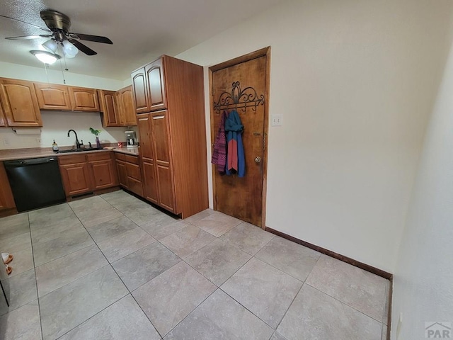 kitchen with baseboards, light tile patterned flooring, ceiling fan, dishwasher, and a sink