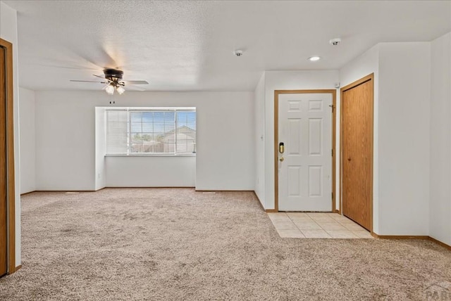 foyer with baseboards, a ceiling fan, light colored carpet, a textured ceiling, and recessed lighting