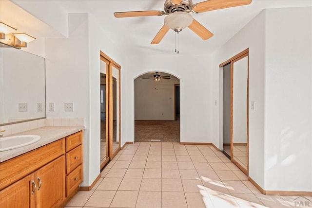 bathroom featuring ceiling fan, tile patterned flooring, and vanity