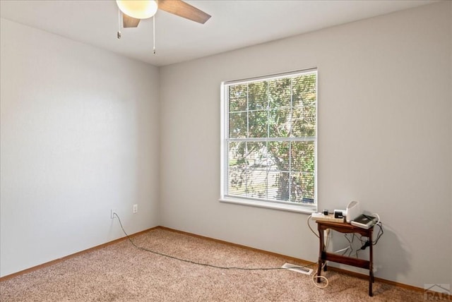 unfurnished room featuring ceiling fan, carpet floors, and baseboards