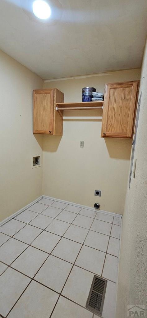 laundry area with cabinet space, visible vents, hookup for a washing machine, hookup for an electric dryer, and light tile patterned flooring