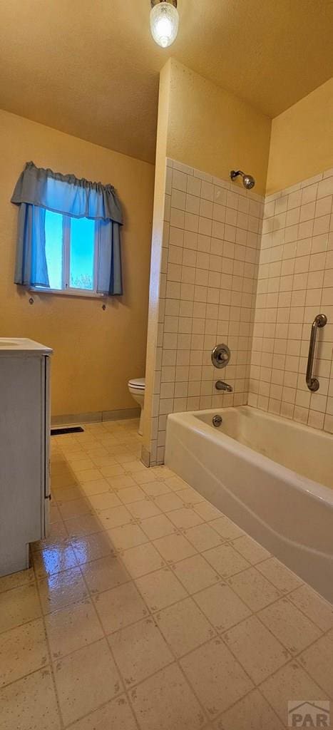 bathroom featuring shower / tub combination, vanity, and toilet