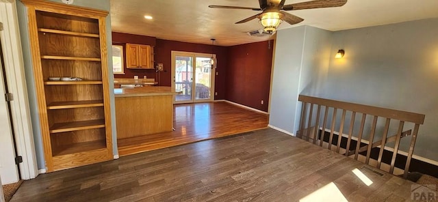 kitchen with dark wood-style flooring, light countertops, visible vents, and open shelves