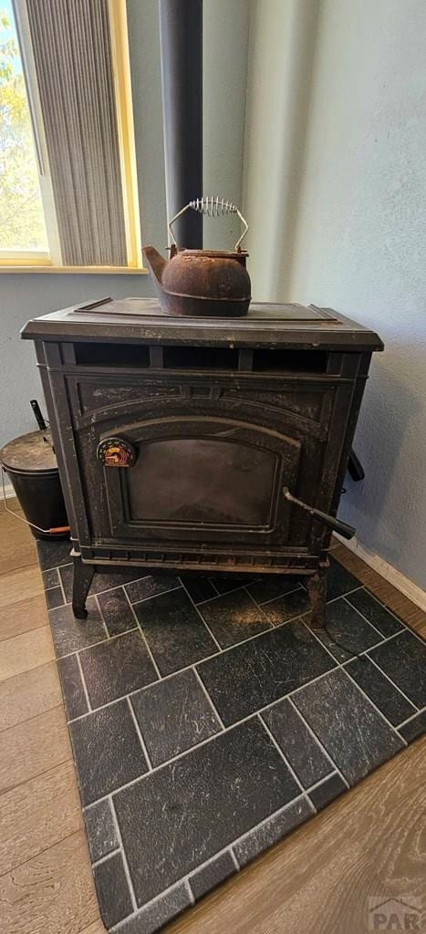 details featuring a wood stove and baseboards