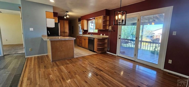 kitchen featuring hanging light fixtures, black dishwasher, open shelves, and light countertops