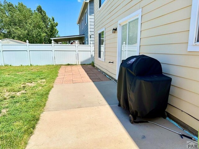 view of patio featuring fence and area for grilling