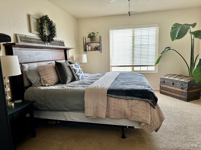 bedroom featuring carpet flooring and visible vents