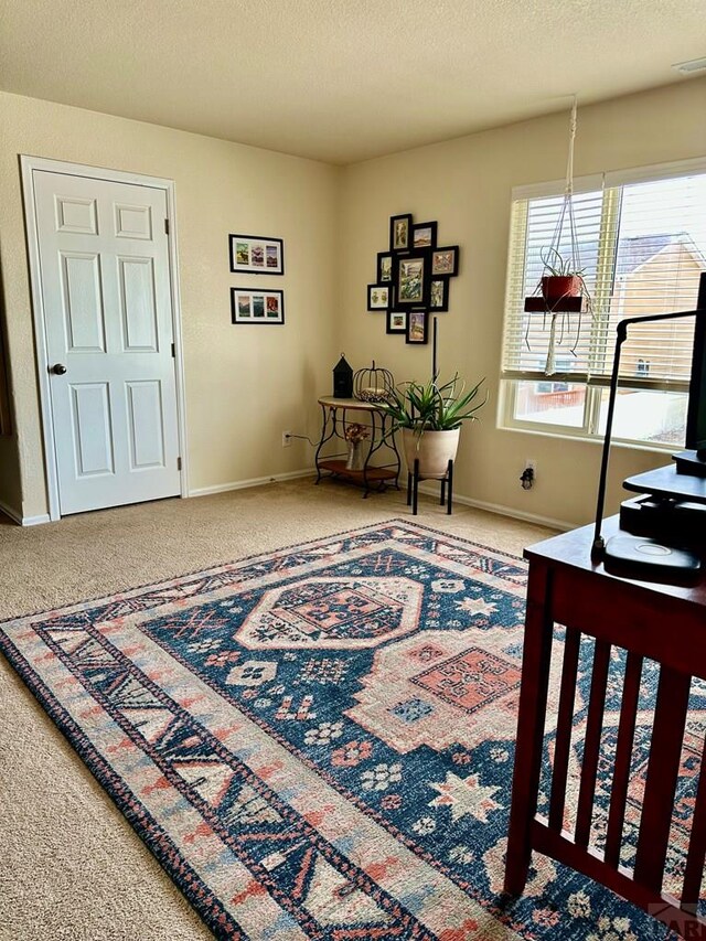 interior space with visible vents, a textured ceiling, and baseboards