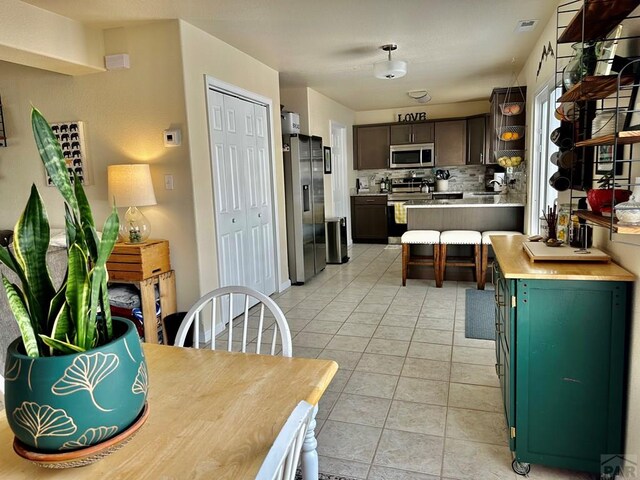 dining room featuring light tile patterned floors and visible vents