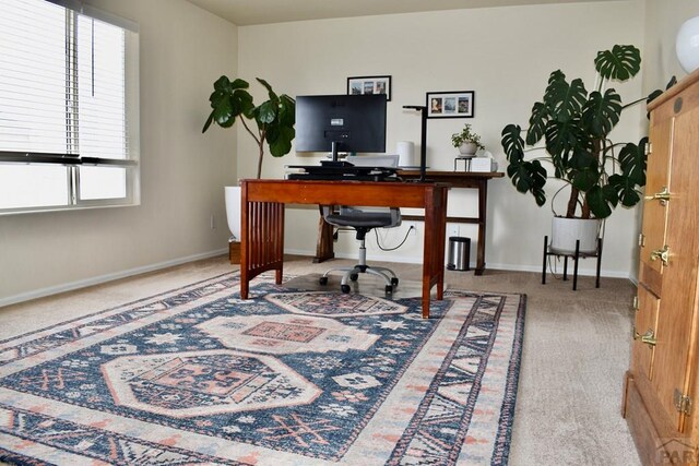 carpeted home office featuring baseboards