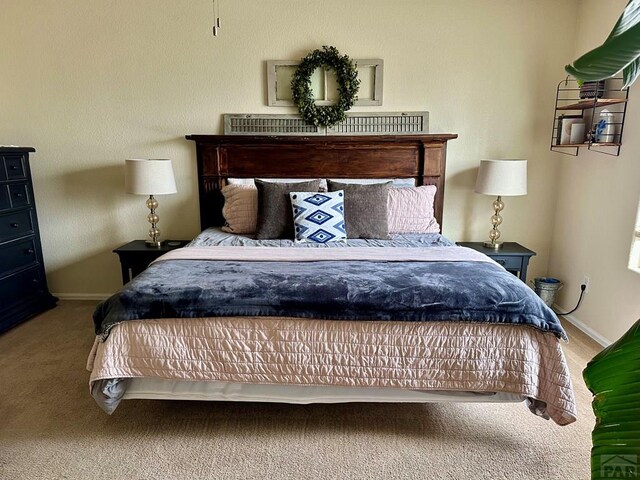 bedroom with baseboards and carpet flooring