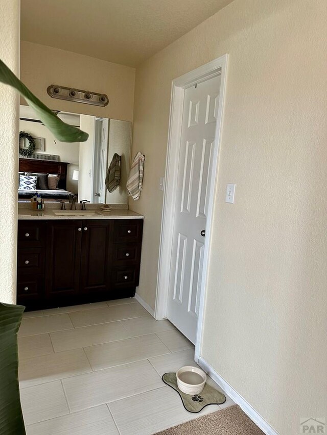 bathroom featuring vanity and baseboards