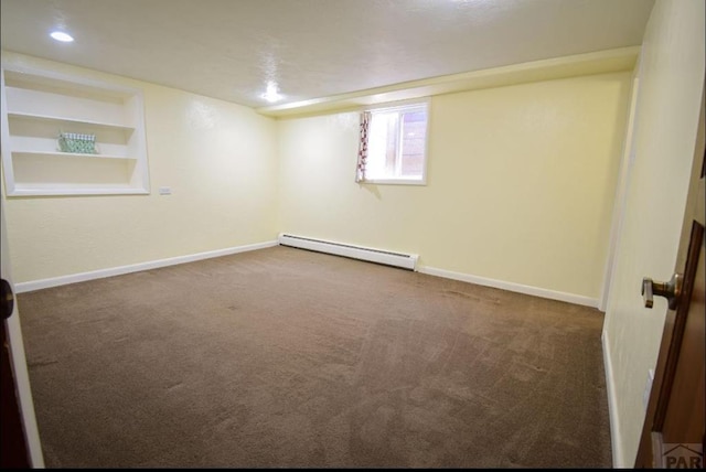 carpeted spare room with built in features, a baseboard radiator, baseboards, and recessed lighting