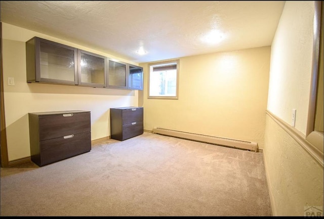 unfurnished office featuring carpet floors and a baseboard radiator