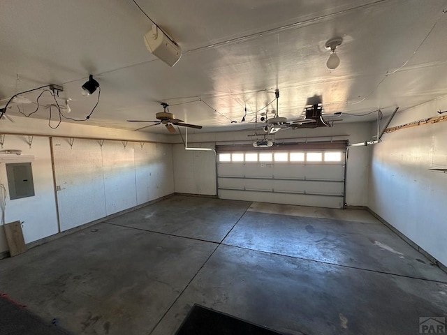 garage with electric panel and a garage door opener