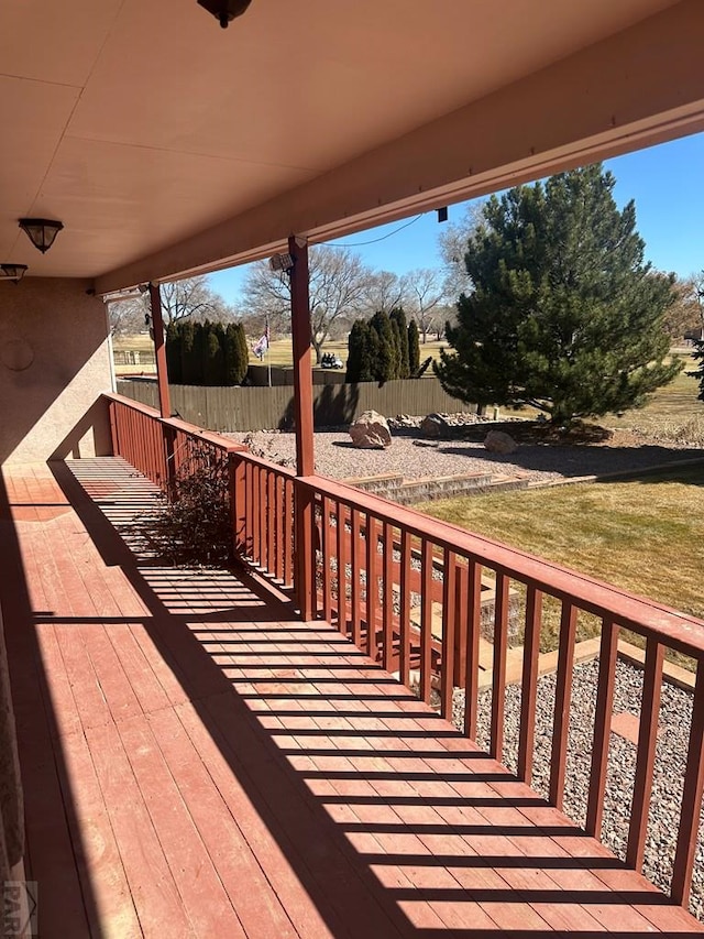 wooden deck with a yard and fence