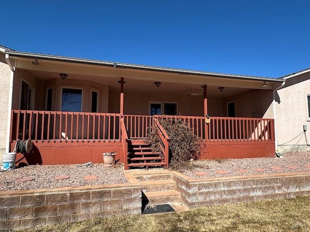 view of front of house featuring covered porch and stucco siding