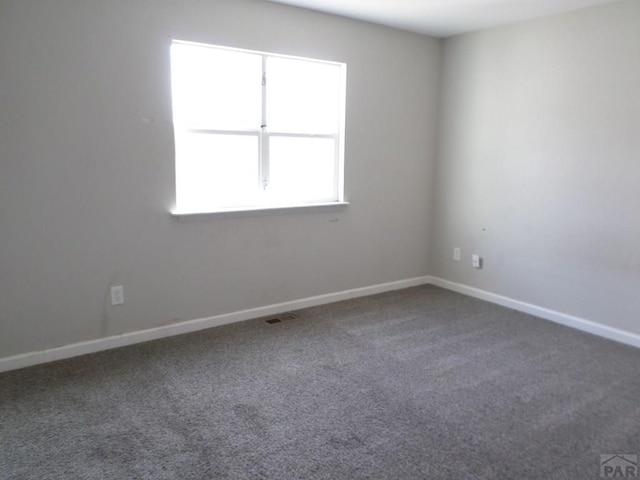 3023 Cascade Ave, Pueblo, CO 81008 - carpeted empty room featuring visible vents and baseboards