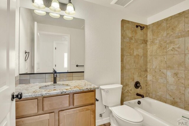 full bathroom with toilet, bathtub / shower combination, visible vents, and vanity