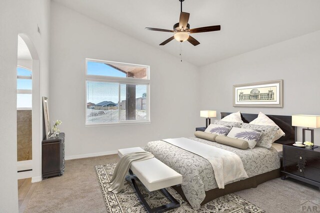 bedroom with baseboards, arched walkways, a ceiling fan, light colored carpet, and lofted ceiling