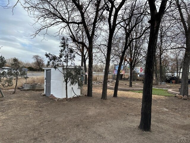 view of yard featuring a shed and an outbuilding