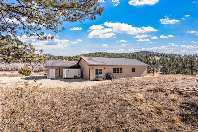 1401 Larkspur Ln, Westcliffe, CO 81252 - back of house featuring stucco siding and metal roof