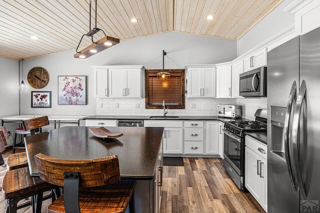 1401 Larkspur Ln, Westcliffe, CO 81252 - kitchen with a sink, dark countertops, stainless steel appliances, lofted ceiling, and wood ceiling