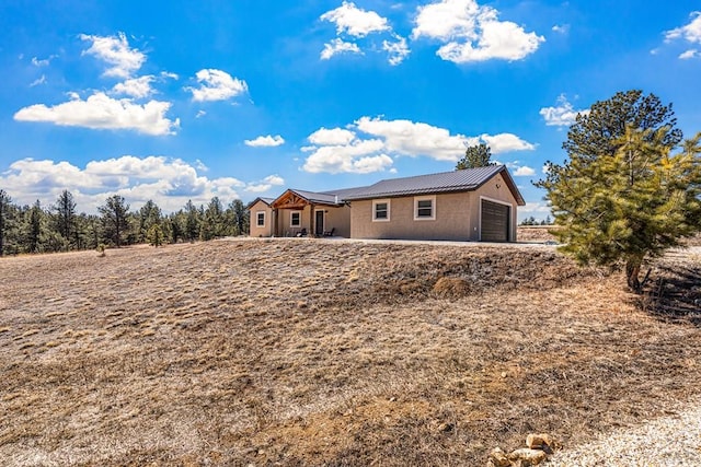1401 Larkspur Ln, Westcliffe, CO 81252 - rear view of property featuring stucco siding and a garage