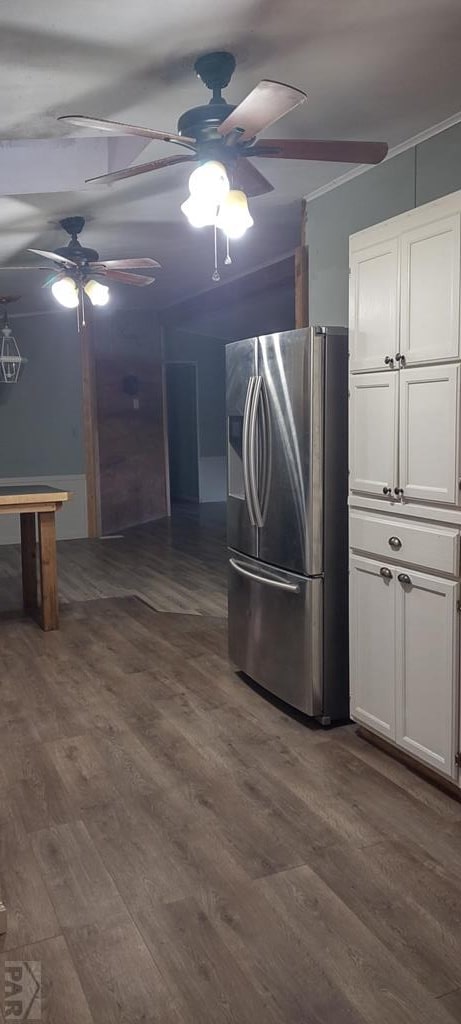 kitchen featuring crown molding, white cabinets, dark wood finished floors, and stainless steel fridge with ice dispenser