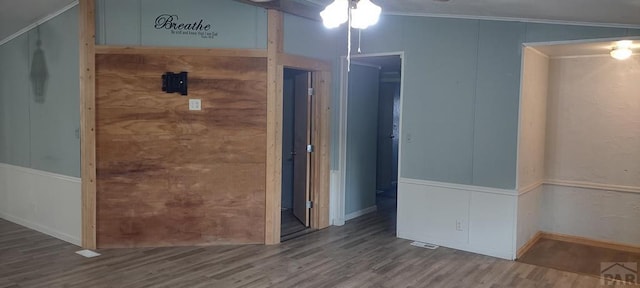 empty room featuring crown molding and wood finished floors