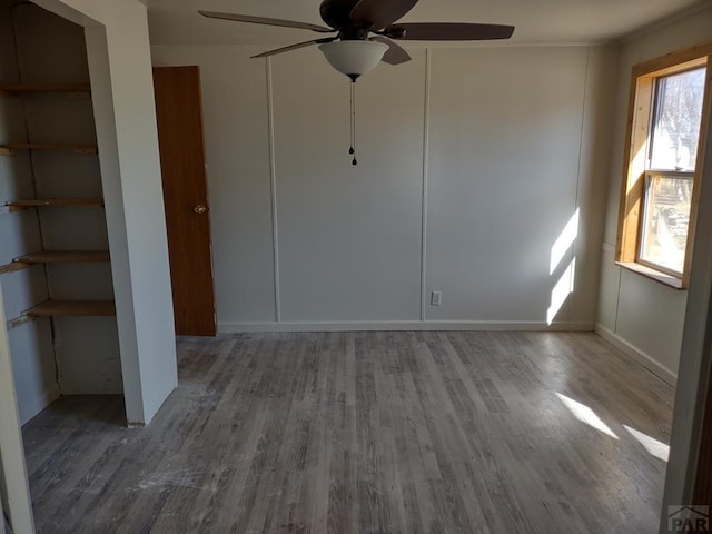 unfurnished bedroom featuring a ceiling fan and wood finished floors