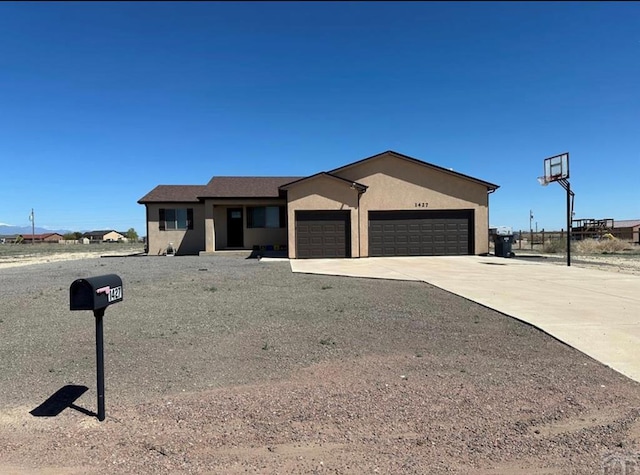 1427 E Kiva Dr, Pueblo West, CO 81007 - single story home featuring a garage, concrete driveway, and stucco siding