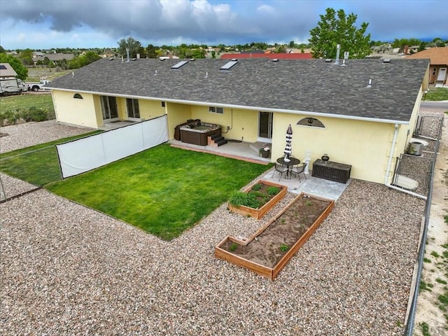 433-435 E Stardust Dr, Pueblo West, CO 81007 - rear view of property with a patio area, stucco siding, a vegetable garden, a hot tub, and a shingled roof