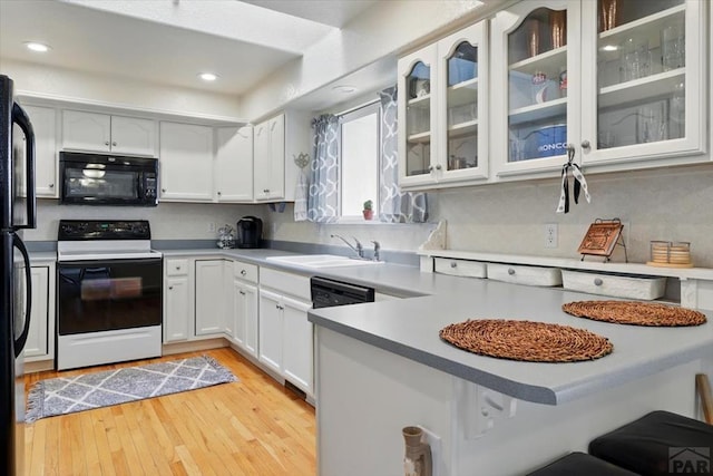 433-435 E Stardust Dr, Pueblo West, CO 81007 - kitchen featuring black microwave, electric range, a sink, white cabinets, and recessed lighting