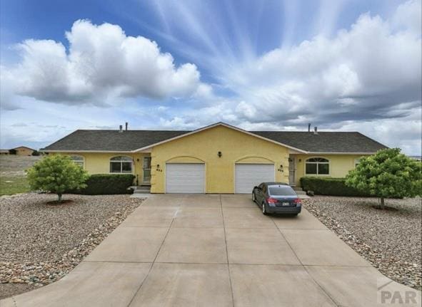 433-435 E Stardust Dr, Pueblo West, CO 81007 - single story home with an attached garage, concrete driveway, and stucco siding