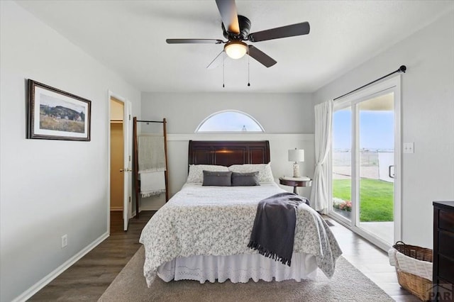 433-435 E Stardust Dr, Pueblo West, CO 81007 - bedroom featuring access to outside, dark wood-style floors, a ceiling fan, a walk in closet, and baseboards