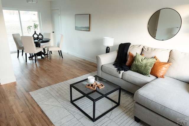 living area with wood finished floors and baseboards