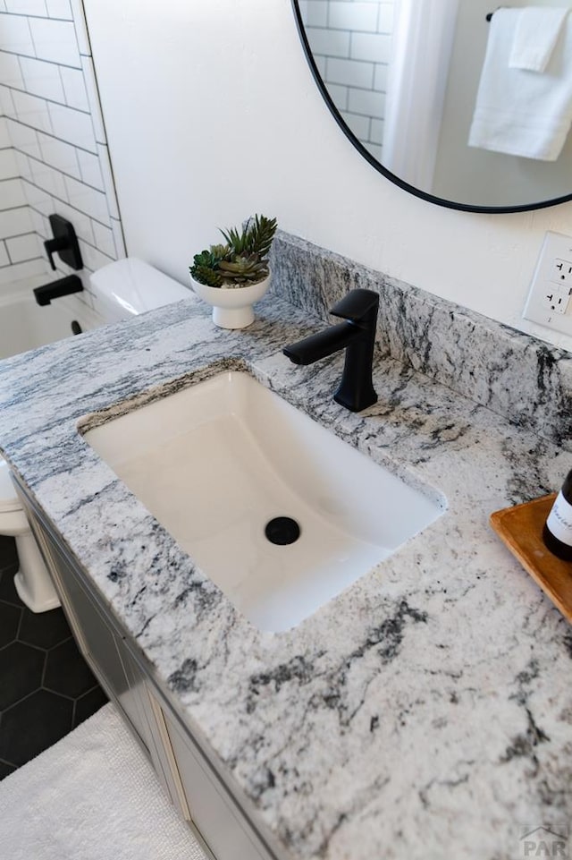 bathroom featuring vanity, toilet, and tile patterned floors