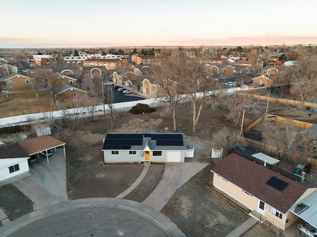 aerial view at dusk featuring a residential view