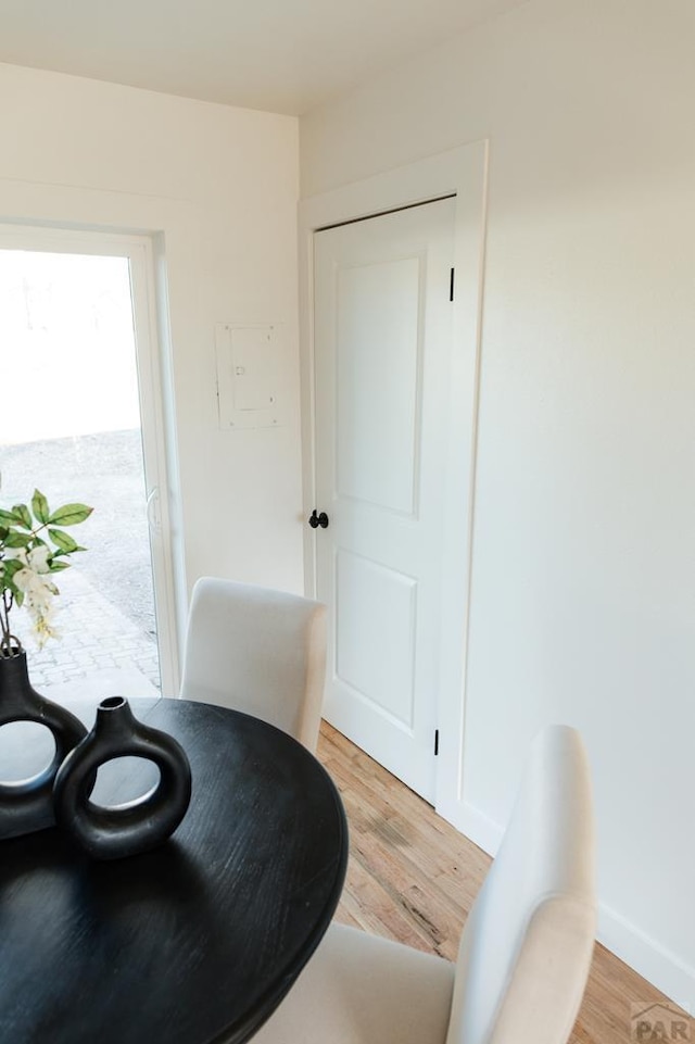 sitting room with light wood-type flooring and baseboards