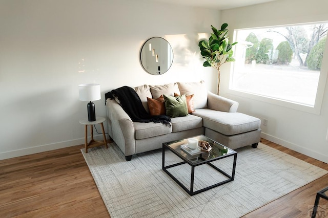 living room featuring light wood-style floors and baseboards